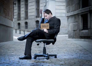 Business Man sitting on Office Chair on Street in stress