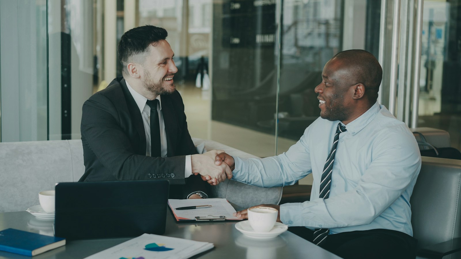 Two businessmen shaking hands after closing a deal